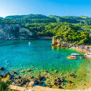 Beautiful beach and boat in Paleokastritsa, Corfu island, Greece